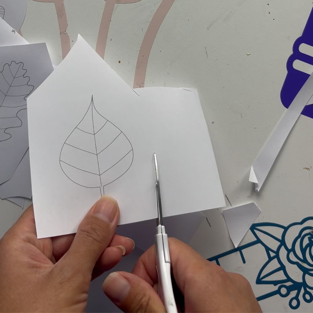 Etape 1 du tuto pour créer un DIY autour de l'automne avec des feuilles en papier glissées entre les livres d'une bibliothèque
