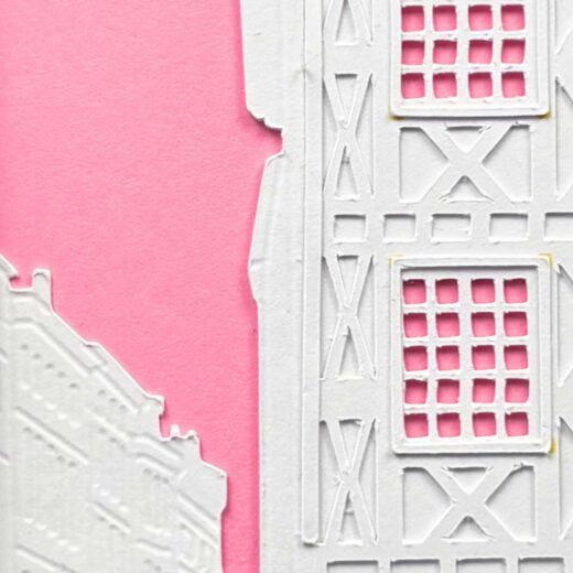 Détail d'une vue de la rue saint-Rome créée par superposition de couches de papier blanc sur un fond rose vif.